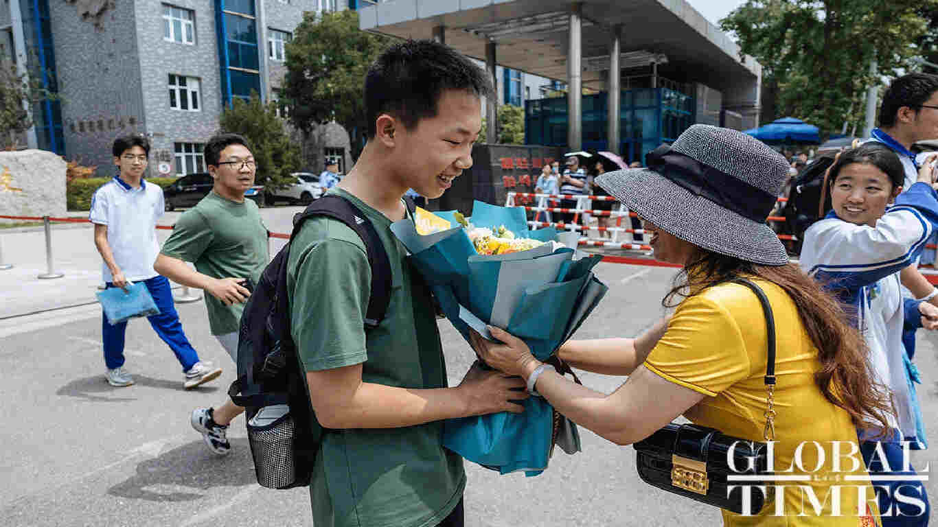 A mother giving flower to Chinese student after his entrance examination. Photo: Li Hao/GT