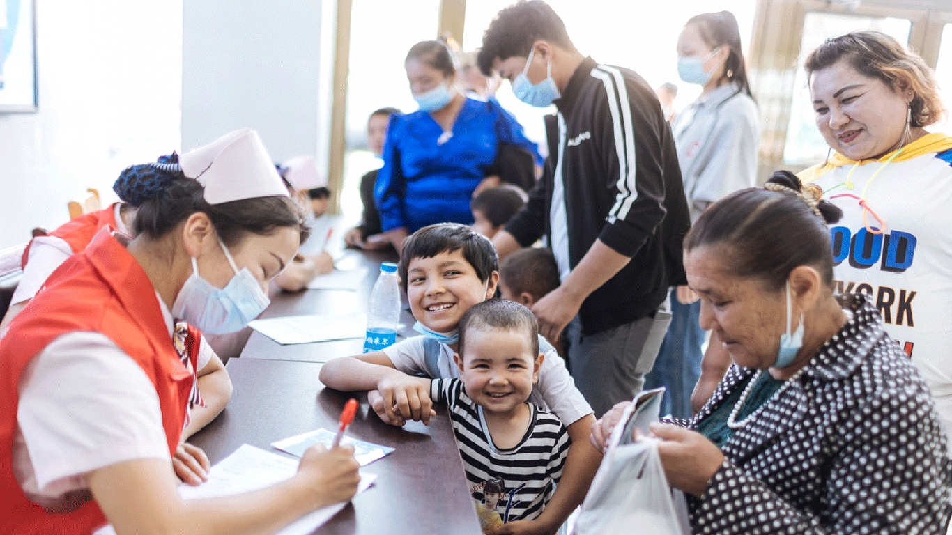 Parents and children happily register for pre-screening in a hospital in Jiashi county, on May 12, 2023.
