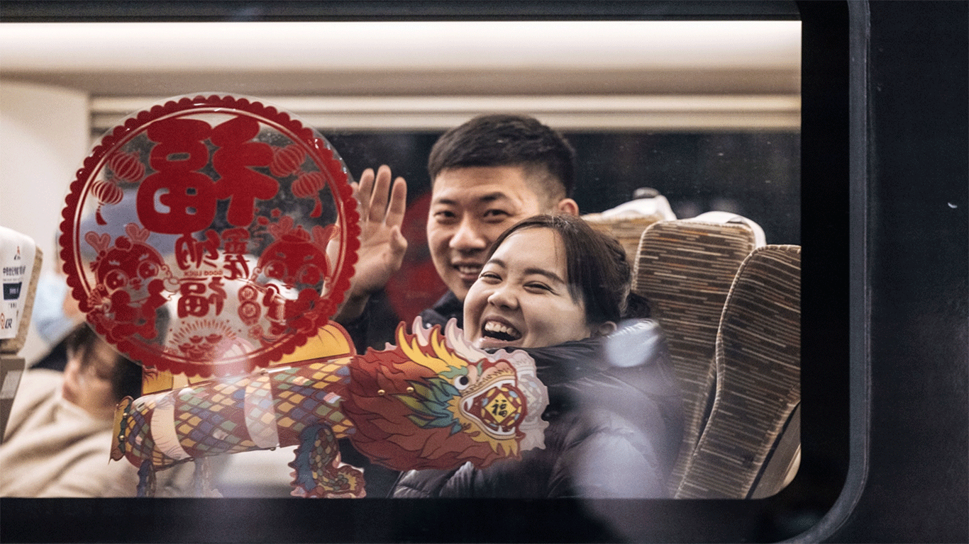 Passengers smile and wave goodbye on a high speed train departing from Beijing West Railway station on January 26, 2024. The train is decorated with dragon-shaped characters as 2024 marks the Year of the Dragon in the Chinese calendar. China's chunyun, or Spring Festival travel rush, the world's largest annual human migration, begins on January 26, 2024. The 40-day chunyun is expected to see a new record of 9 billion passenger trips. Photos: Li Hao/GT
