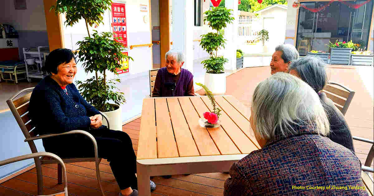 Senior residents chat in the yard of "Run Nian Zhi Jia" elderly people's home